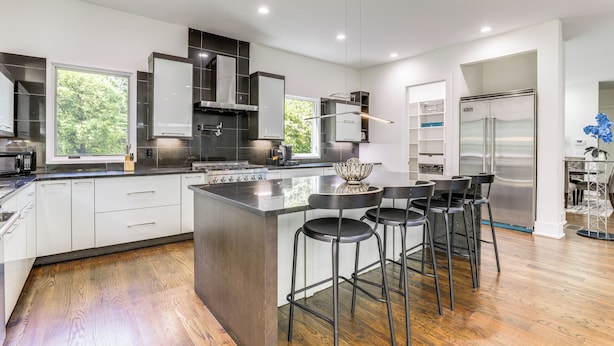 A modern kitchen with a central island, bar stools, and a stainless steel refrigerator. - Luxe Buckhead Retreat 6 Mi to Dtwn Atlanta (Atlanta)