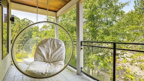 A hanging chair in a room with large windows overlooking a lush green landscape. - Luxe Buckhead Retreat 6 Mi to Dtwn Atlanta (Atlanta)