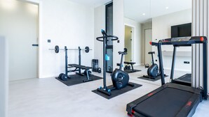 A modern home gym with a treadmill, weight bench, and exercise bike. - Villa Belvedere 1 Zadarvillas (Sveti Filip i Jakov)