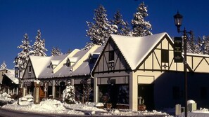 A row of traditional chalet-style buildings with snow-covered roofs and a clear blue sky in the background. - Hot Tub-Game Tables Aspen Glen (Big Bear Lake)