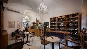 A cozy bar area with wooden furniture, a large wine rack, and a chandelier. - Kaiserstein Palace Apartments (Prague)
