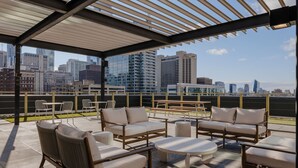 A rooftop terrace with outdoor seating, a pergola, and a city skyline view. - Sosuite One Bed Apt Accessible w Rooftop Gym Laundry (Philadelphia)
