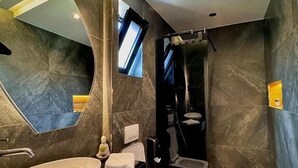 A modern bathroom with a large mirror, a freestanding sink, a bidet, and a shower. - Martin Empire (Gjirokastër)