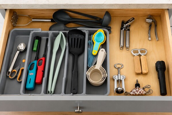 A drawer with various kitchen utensils and tools organized neatly. - 4-bedroom house in serene Avon with ocean view! Book your getaway now (Avon)