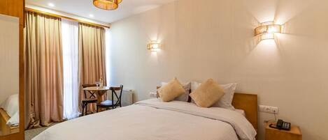 Deluxe Double Room, Courtyard View | In-room safe, blackout drapes, iron/ironing board, free WiFi