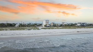 A coastal view with a beachfront property featuring multiple buildings, a sandy beach, and a view of the ocean. - Large Luxury Beach House with Pool (Port St. Joe)