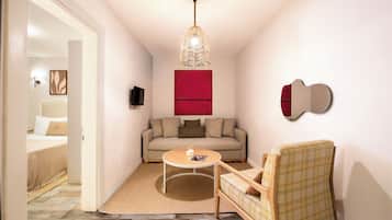 Family Studio Suite | Living area | 40-cm TV with satellite channels
