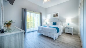A bedroom with a bed, bedside tables, a ceiling fan, and a window with curtains. - Lakefront Condo w/ 6 Heated Pools | Near Disney! (Davenport)