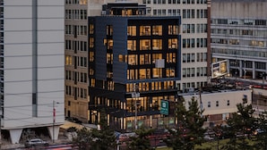 A Drexel University College of Medicine building with a modern architectural design, surrounded by other urban structures.
