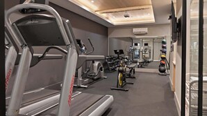 A gym with treadmills, stationary bikes, and various exercise equipment.