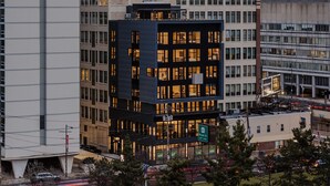 A Drexel University College of Medicine building with a modern architectural design, surrounded by other urban structures.