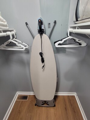 A dental clinic with two dental chairs, a white ceiling, and a wooden floor.