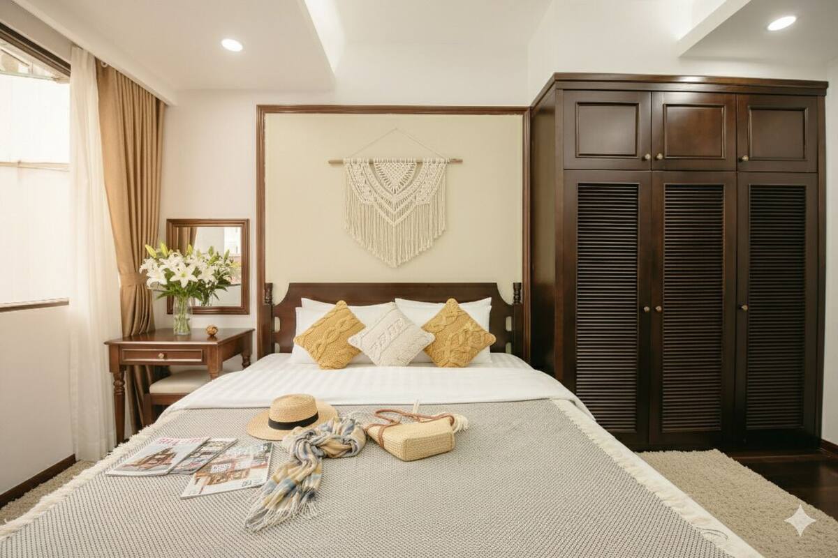 A neatly arranged bedroom with a bed, bedside table, and a wardrobe.