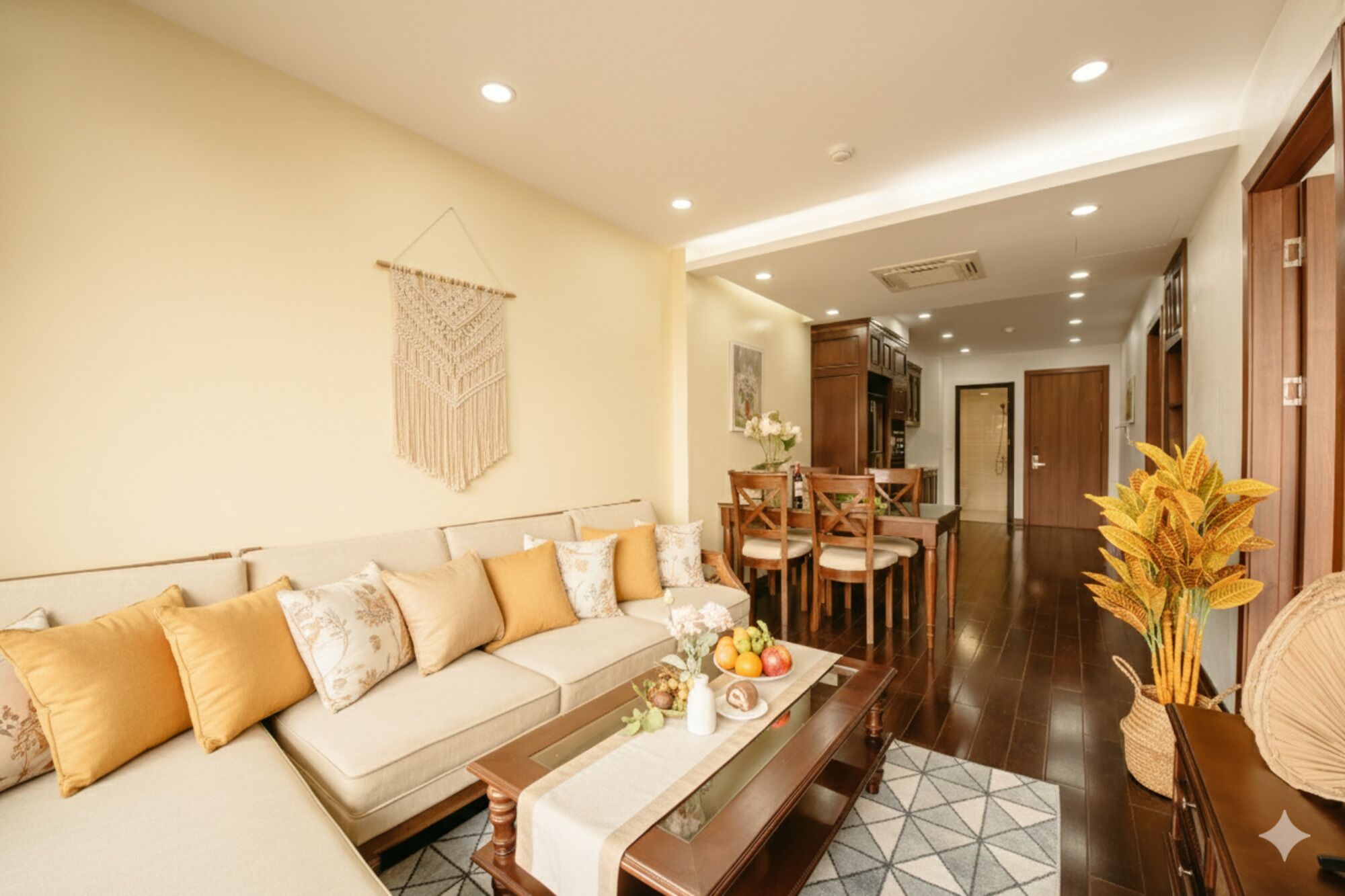 A living room with a sofa, coffee table, and dining area.