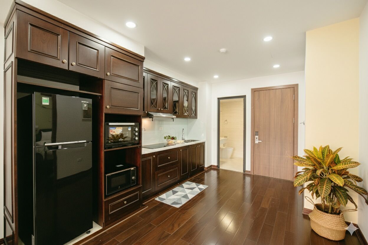 A modern kitchen with dark wood cabinets, a black refrigerator, and a microwave.