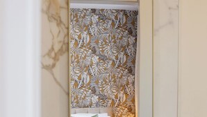 A bathroom with a marble sink, a mirror, and a floral wallpaper. - The Oyster House (Clarinbridge)