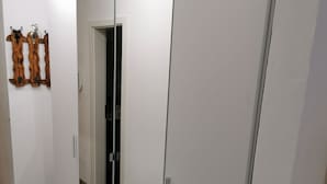 A room with a wardrobe, a door, and a wall-mounted decoration.