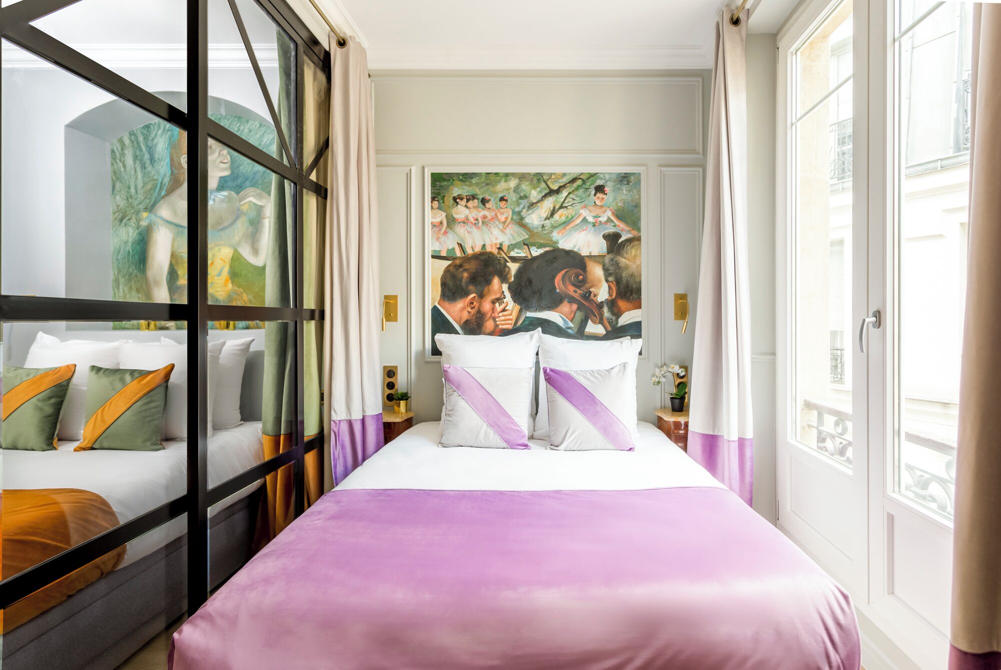 A hotel room with a bed, a large window, and a painting on the wall.