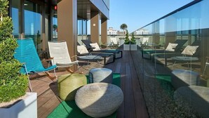 A rooftop terrace with lounge chairs, ottomans, and a small pool area. - Student Only Cumberland Place (Southampton)