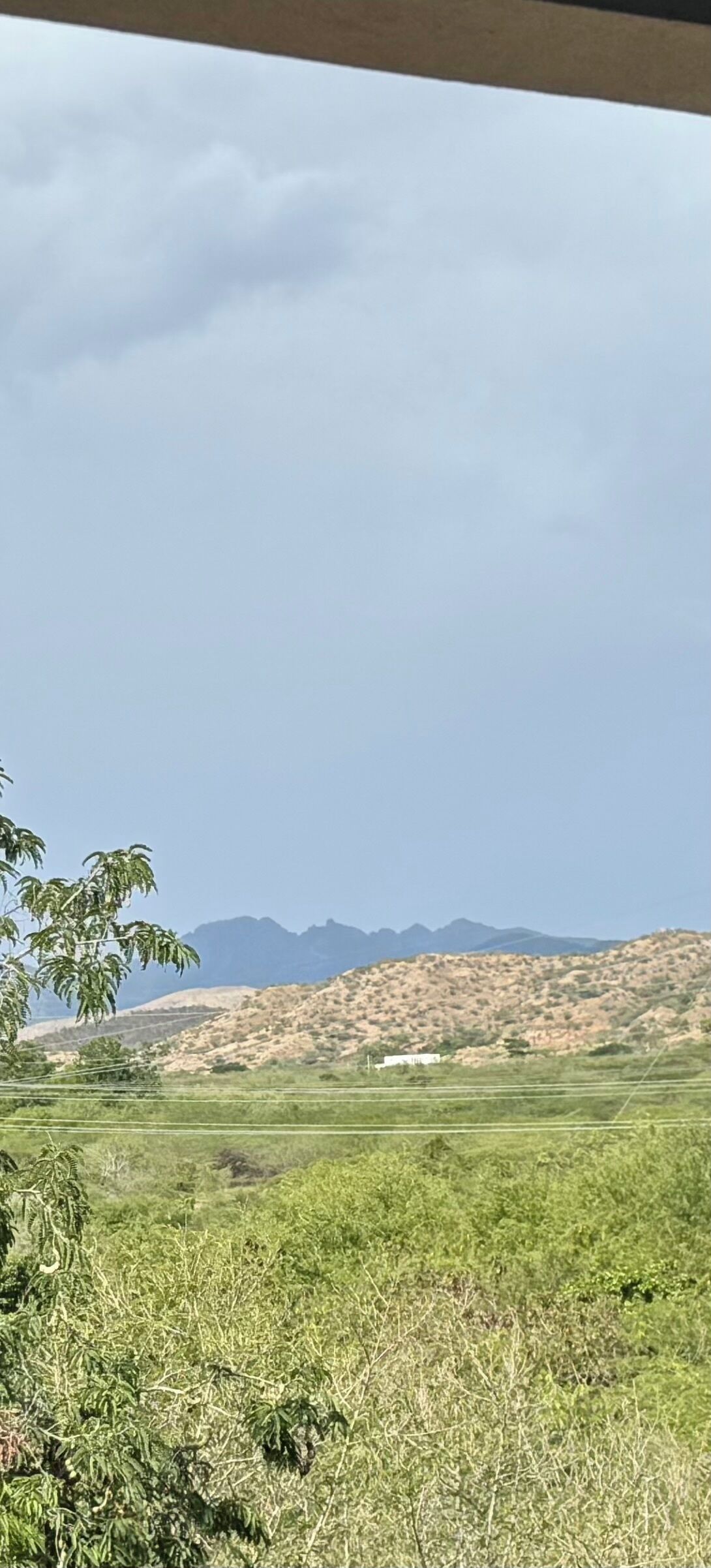 A landscape with a view of distant mountains and a clear sky.