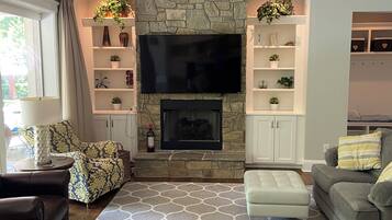 Smart TV, fireplace, books, printers