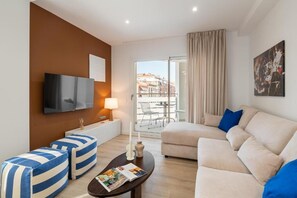 Apartment, Patio, City View | Living area | Flat-screen TV