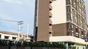 A modern multi-story building with a sign reading "Plume Residence." - Plume Residence Minburi (Bangkok)