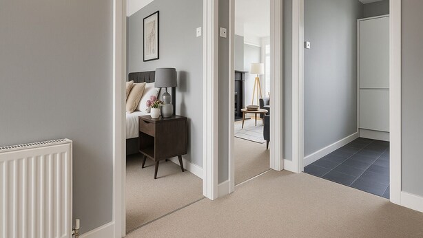 A hallway with a bed, bedside table, lamp, and a framed picture on the wall. - Beautiful 1 bed flat in Wimbledon (London)