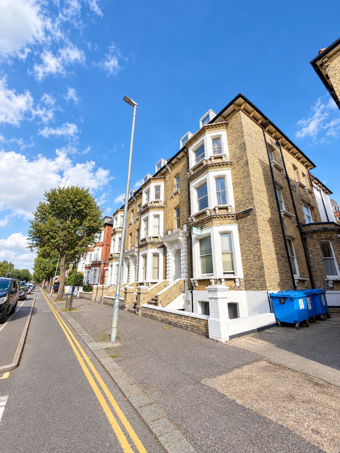 A row of terraced houses with a clear sky.