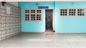 A hostel entrance with a sign reading "WR7 HOSTEL R", stone walls, and tiled flooring. - WR7 Hostel (Sao Bernardo do Campo)