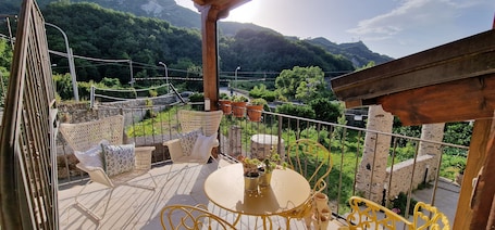 Outdoor dining. Rural house with large garden and vegetable garden in the mountains