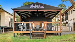 A covered outdoor seating area with a sign reading "Black Shack." - Black Shack - 13 Paisley Island (Paisley)