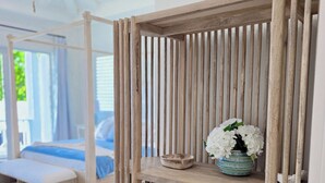 A wooden shelf unit with a bowl and a vase of flowers.