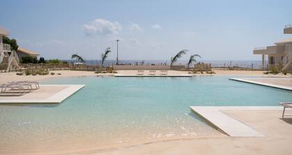 GuestHost - Charming 40 sqm apartment with sea view, able to accommodate 4 people, located inside the renowned Borgo84 residence, equipped with swimming pool and cycle path. The property is located just 3 km from the center of Marzamemi, one of the most