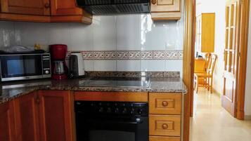Comfort Apartment, Balcony, Garden View | Private kitchen | Highchair, freezer