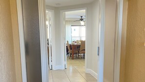 A hallway with a door leading to a dining area. - Cozy 2-bedroom condo with WiFi, AC in Orlando - Close to Universal and Disney (Orlando)