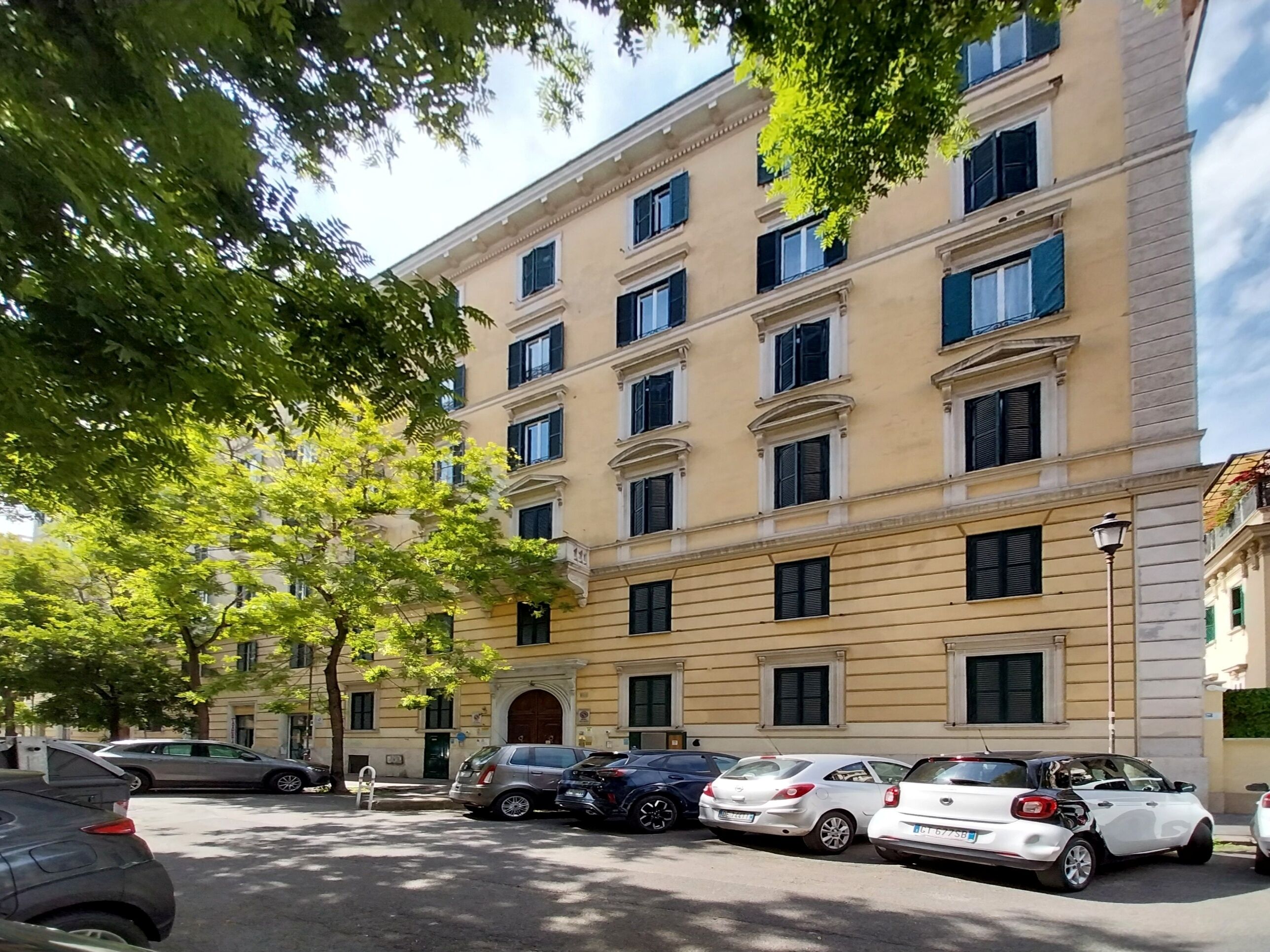 A multi-story building with a classic architectural style, featuring a symmetrical facade, evenly spaced windows, and a central entrance.