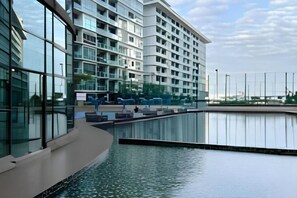 A modern building with a reflective pool in front. - Mount austin Lake City view palazio by Natol (Johor Bahru)