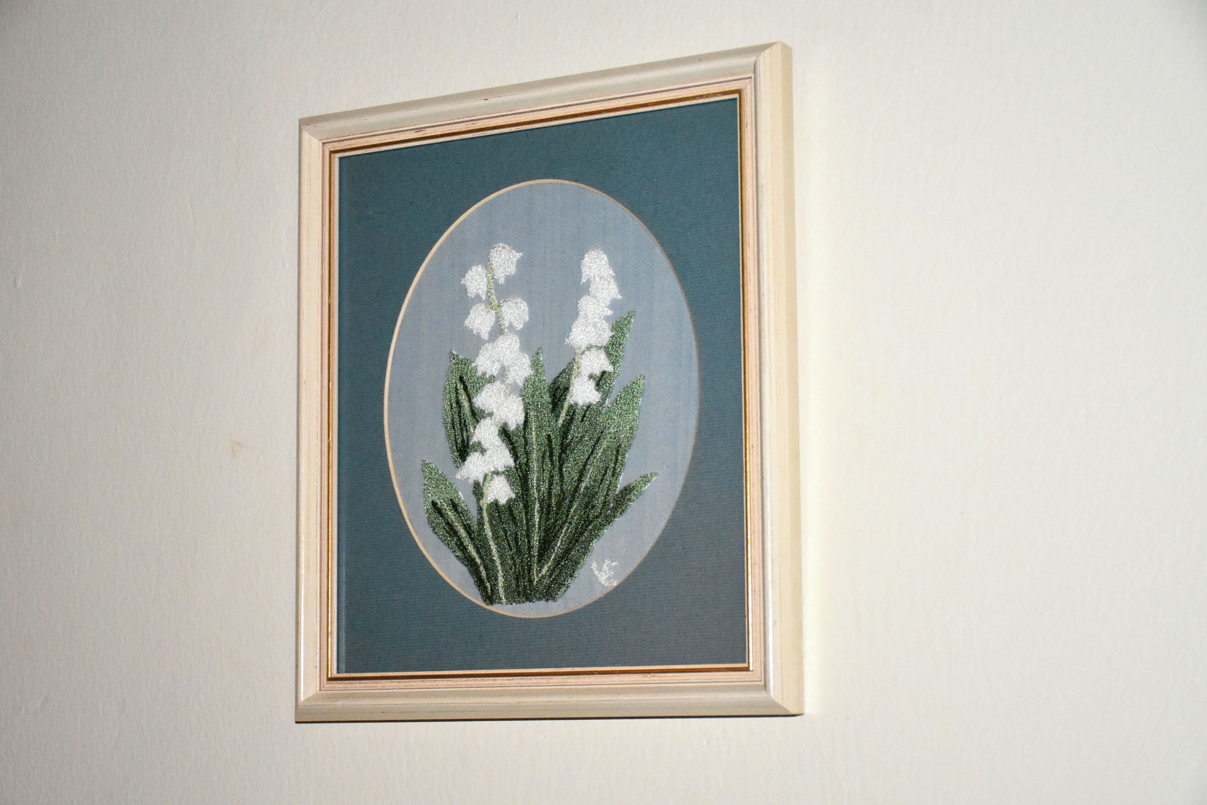 A framed botanical illustration on a wall.