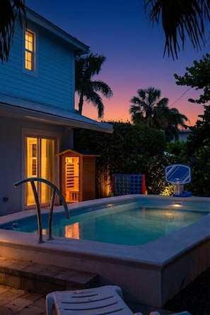 A swimming pool with a basketball hoop, a wooden structure, and a house with a blue exterior. - Movie Theater, Heated Pool, & Sauna - Luxe 4BR (West Palm Beach)