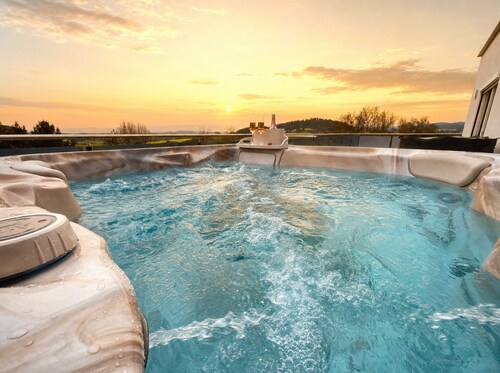 Modern penthouse with a hot tub, sauna, mountain views, home theater, and foosball table