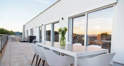 Modern penthouse with a hot tub, sauna, mountain views, home theater, and foosball table