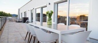Modern penthouse with a hot tub, sauna, mountain views, home theater, and foosball table