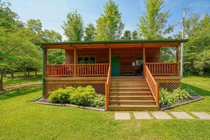 A wooden cabin with a porch, steps, and a green door. - Sheets Retreat | Hocking Hills, 80 Acres, Pond (New Plymouth)
