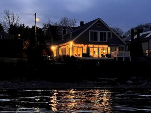 A house with a large porch and a view of the water.