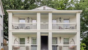 A two-story white building with balconies, numbered 1 to 4, and a central entrance. - Optimist Abode 1: Chic Stay on Greenway, less than 7 min to NoDa-Midwood-Uptown (Charlotte)