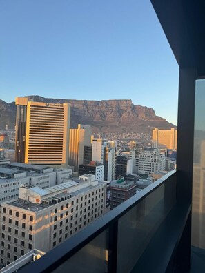 A cityscape with a prominent building labeled "Southern Sun" and a mountain in the background. - The Rubik Deluxe Apartment (Cape Town)