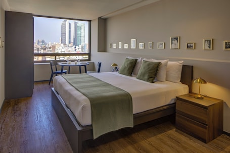 Premium Suite | Minibar, in-room safe, laptop workspace, blackout drapes. Colony Residences & Suites