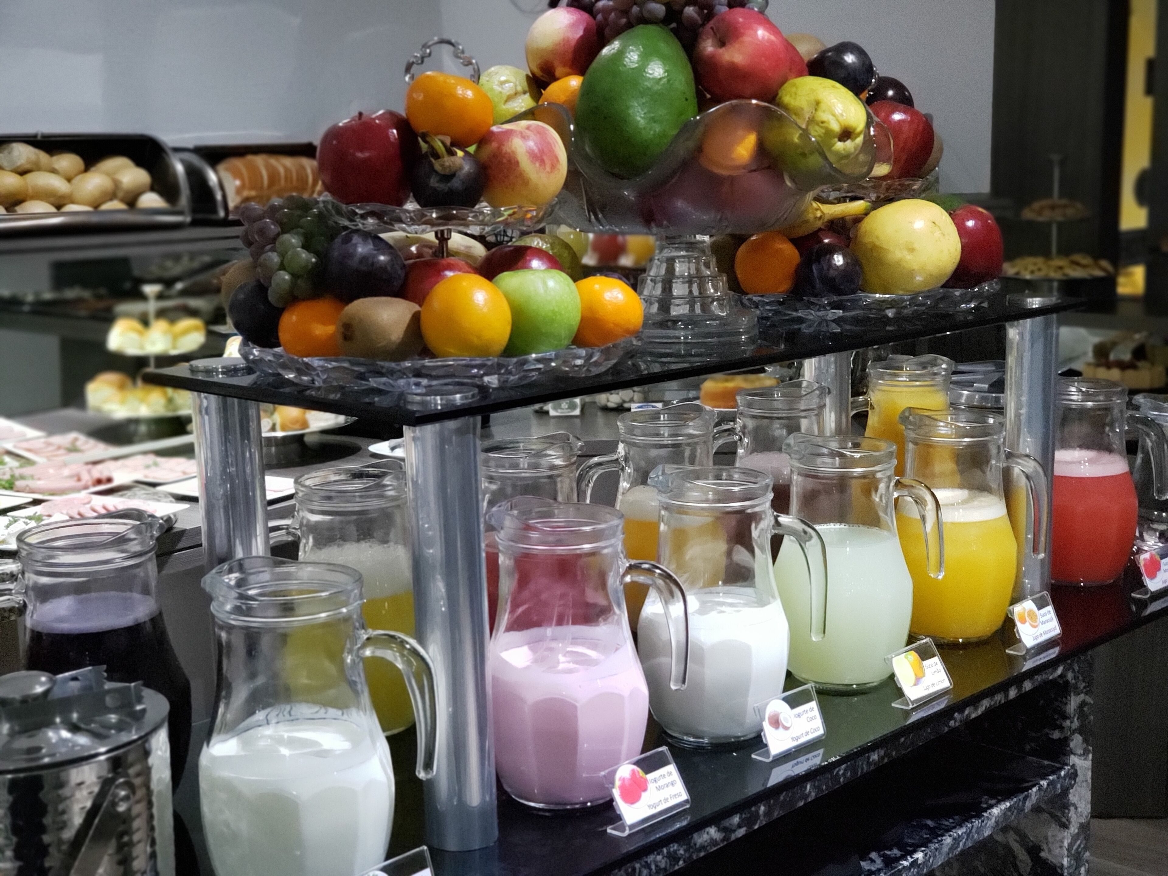 A buffet with various fruits and beverages.