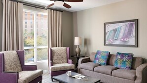 A hotel room with two armchairs, a sofa, a coffee table, and a painting on the wall. - Lovely Las Vegas 1BD Suite Near the Strip! (Las Vegas)